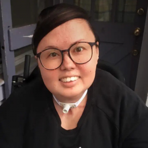 Stacey Park Milbern, a mixed race Korean and white queer person, smiling at the camera.